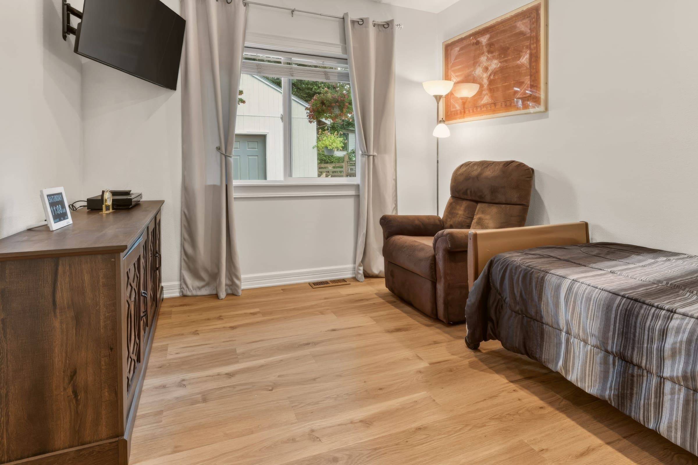 Bedroom with a recliner chair beside a bright window